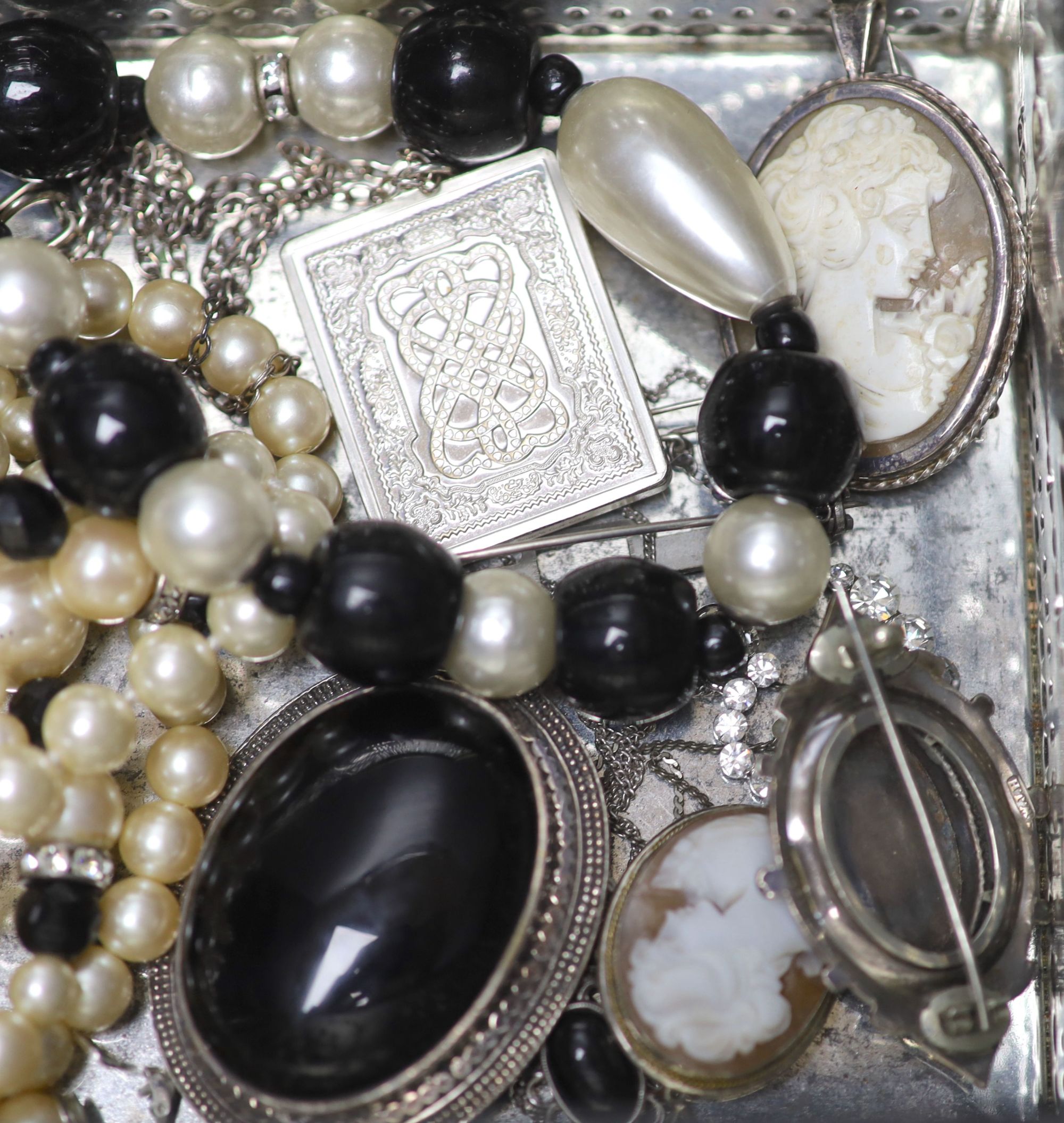 A silver locket, silver chains, a cameo brooch and a group of assorted costume jewellery.